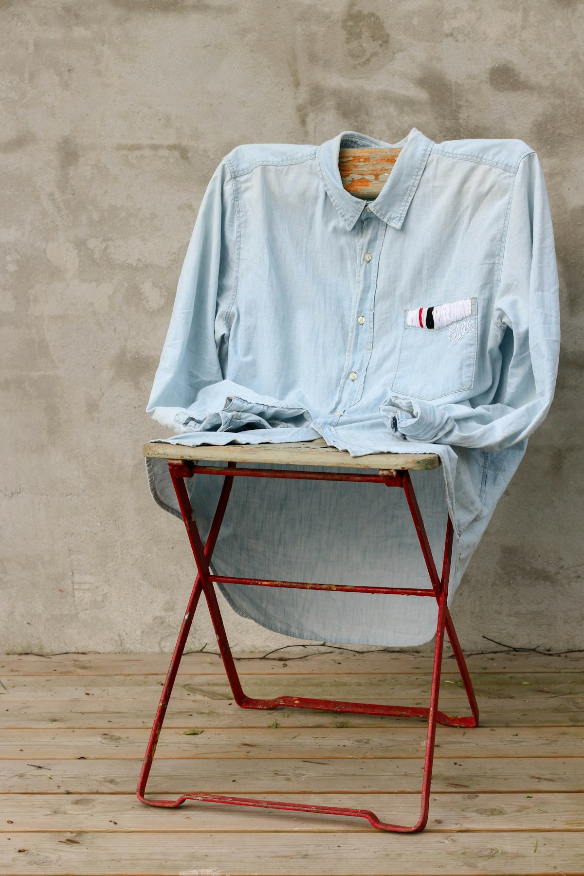 Minimalist capsule wardrobe with neutral clothing on wooden hangers